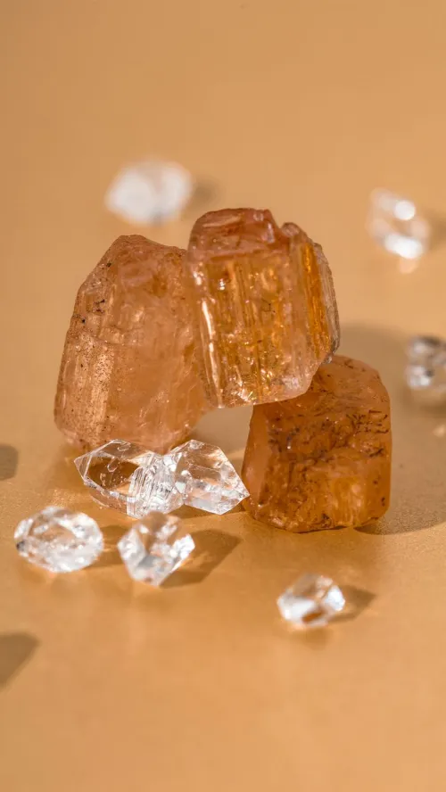 Topaz and citrine gemstones under different lighting conditions showing refraction differences